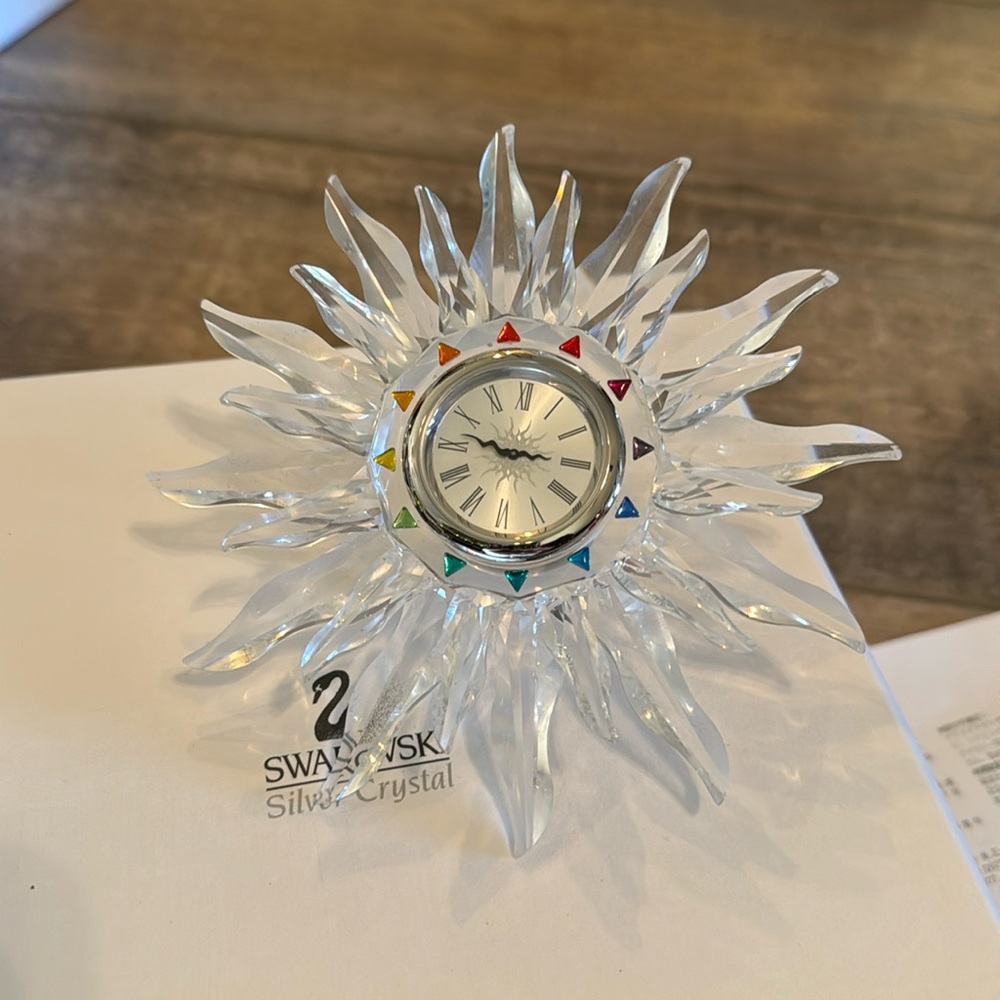 Swarovski clock with authenticity certificate.